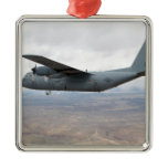 A C-130 Hercules soars through the sky Christmas Tree Ornaments