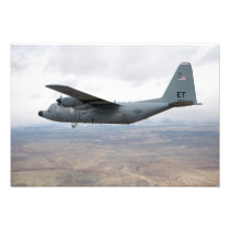 A C-130 Hercules soars through the sky
