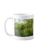 A cottage tucked away coffee mug