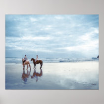 A couple riding horses on Parkiri beach in New Posters