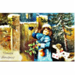 A girl knocks the gate of a house with gifts along photo sculpture