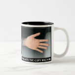 a hand with the copy machine mug