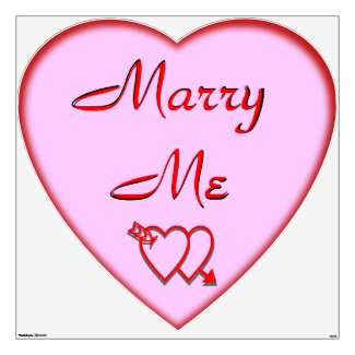 A HUGE 4 foot heart shaped wall decal in pink with the text 'Marry Me' above two interlocking hearts with the arrow of love for St Valentines Day