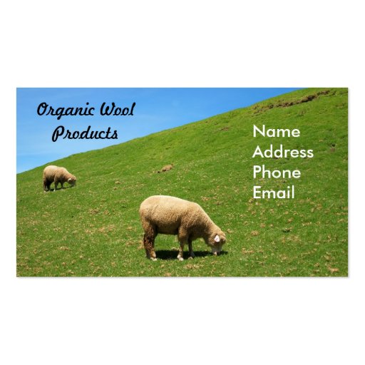A lush green pasture with two sheep grazing business cards