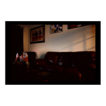 a man sitting in a room alone posters