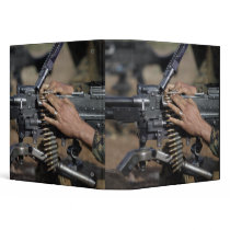 A Marine loads a M-240G machine gun Binders