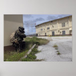 A Marine posts security posters