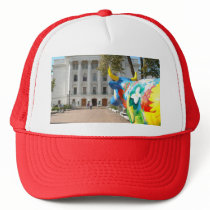 A Painted Cow Admires the Capital Building Trucker Hat