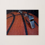 A referee's whistle rests on top of a jigsaw puzzles