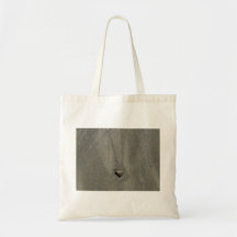 A Single Stone Lying in Sand Tote Bag