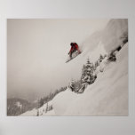 A snowboarder jumps off a cliff into powder in poster