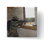 A soldier acts as an opposition force pinback buttons