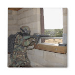 A soldier acts as an opposition force refrigerator magnet