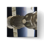 A Soyuz spacecraft backdropped by Earth Pinback Button