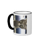A Soyuz spacecraft backdropped by Earth Coffee Mug