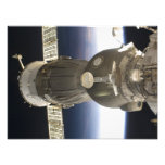 A Soyuz spacecraft backdropped by Earth