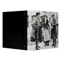 A Suffragette selling newspapers to two 3 Ring Binders