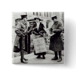 A Suffragette selling newspapers to two Pinback Button