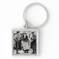 A Suffragette selling newspapers to two Keychains