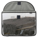 A surfboard sits on the beach in Florida on cliff Sleeves For Macbooks