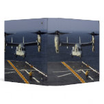 A V-22 Osprey aircraft prepares to land binders