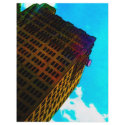 A vibrant and tall building against the  blue sky flyers