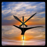 A whales tail at sunset wall clocks