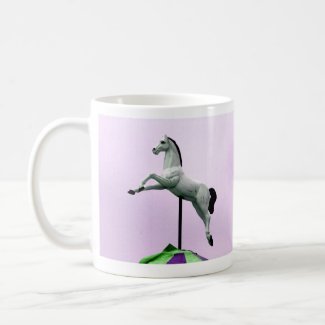 A white horse carousel statue against purple mug