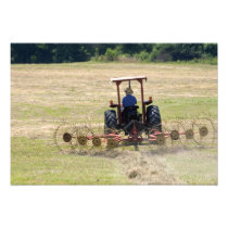 A young boy driving a tractor harvesting