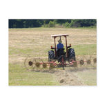 A young boy driving a tractor harvesting post card