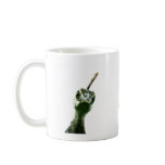 A young peacock's head peering over to say hi! coffee mugs