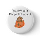 round_button - An adorable African American baby sits inside an orange pumpkin and kid style text reads "Just arrived in time for Halloween!" on babys 1st Halloween T-shirts, tote bags, magnets, and more.: Sizes 