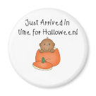 round_magnet - An adorable African American baby sits inside an orange pumpkin and kid style text reads "Just arrived in time for Halloween!" on babys 1st Halloween T-shirts, tote bags, magnets, and more.: Sizes 