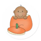 round_sticker - An African American baby inside an orange pumpkin on Halloween cards, tote bags, T-shirts, bodysuits, magnets, and other Halloween items you can customize yourself with text or a name!: Sizes 