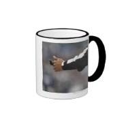 American football referee holding whistle, coffee mugs
