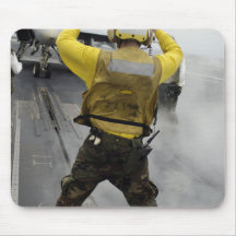 An aircraft director signals a F/A-18C Hornet Mouse Pad