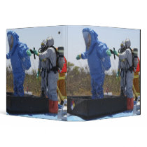 An airman stands in a tub binders