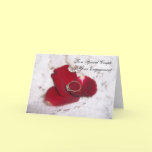 An Engagement Card Diamond Ring And Rose Petals