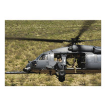 An HH-60 Pave Hawk flies over the desert