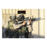 An infantry scout aims his weapon