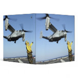 An MV-22 Osprey launches from the USS Nassau binders
