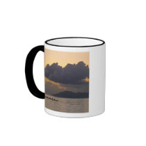 An outrigger canoe team practices off the coast coffee mug