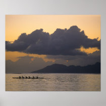 An outrigger canoe team practices off the coast
