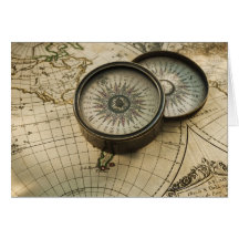 Antique compass on map card