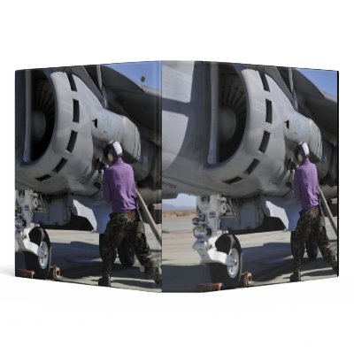 Aviation fuel technician attaches a fuel line 3 ring binders by stocktrek