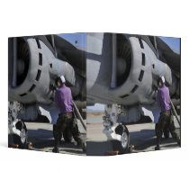 Aviation fuel technician attaches a fuel line 3 ring binders