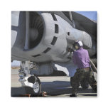 Aviation fuel technician attaches a fuel line fridge magnets