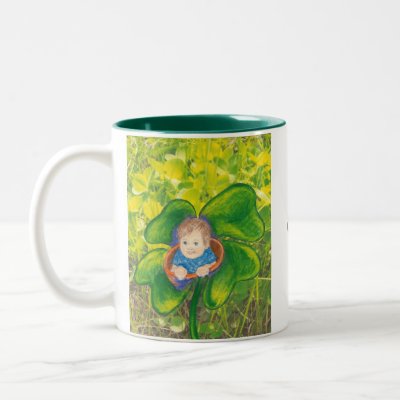 Baby in a clover field. mugs