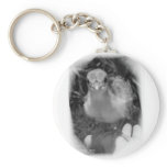 Baby peacock chick standing in a hand keychains