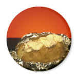 Baked potato with sour cream, against orange backg magnet
